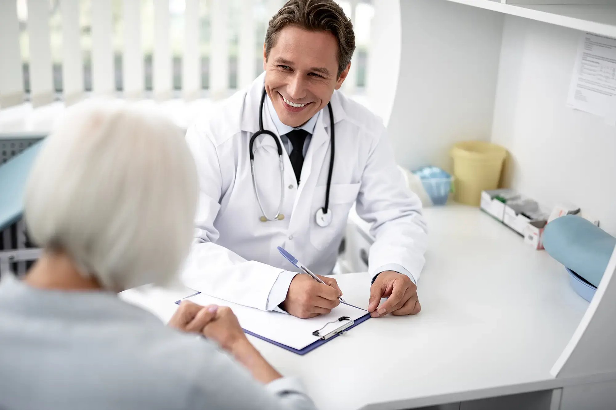 smiling-doctor-health-provider-conducting-patient-consultation