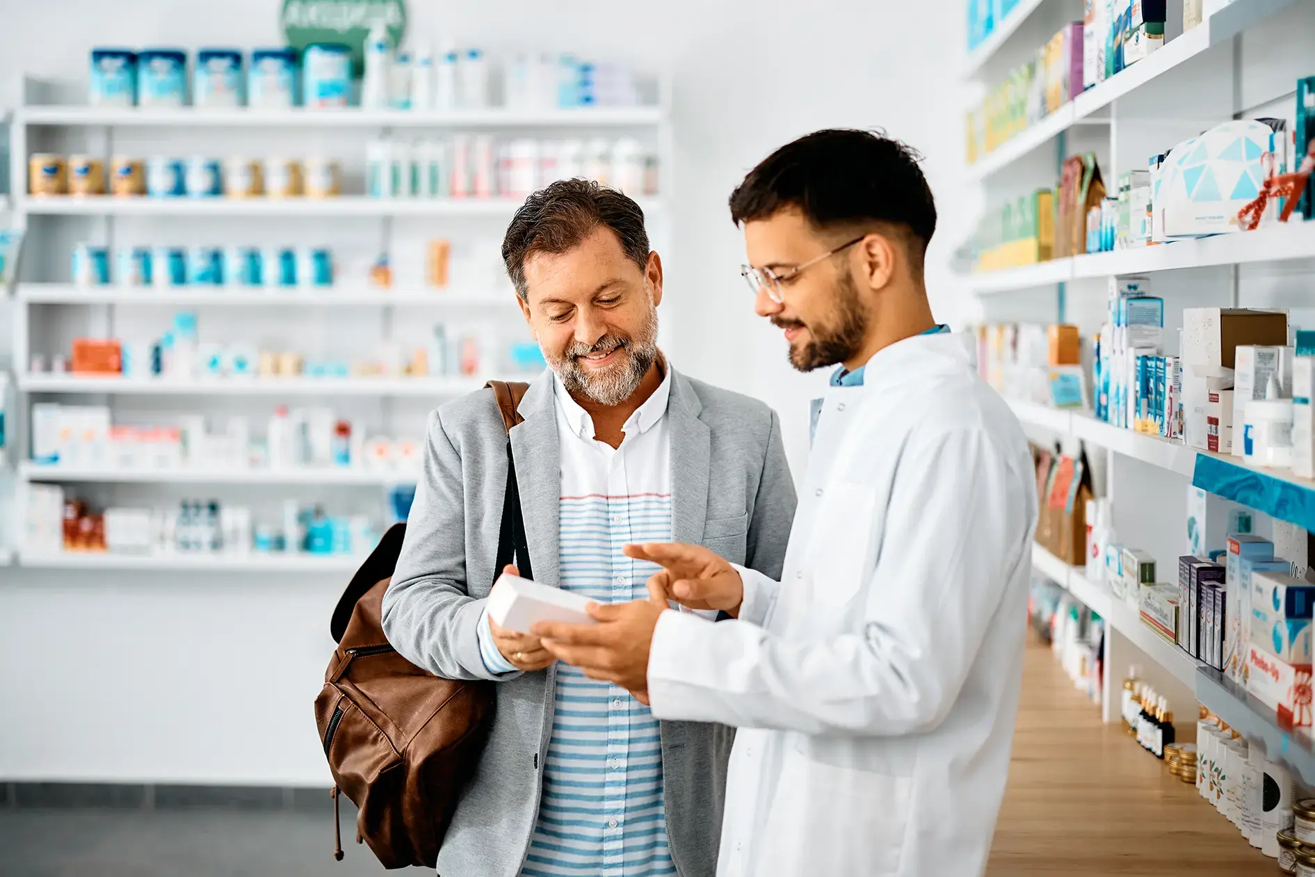 accommodating-pharmacist-explaining-medicine-prescription-to-male-patient accommodating-pharmacist-explaining-medicine-prescription-to-male-patient